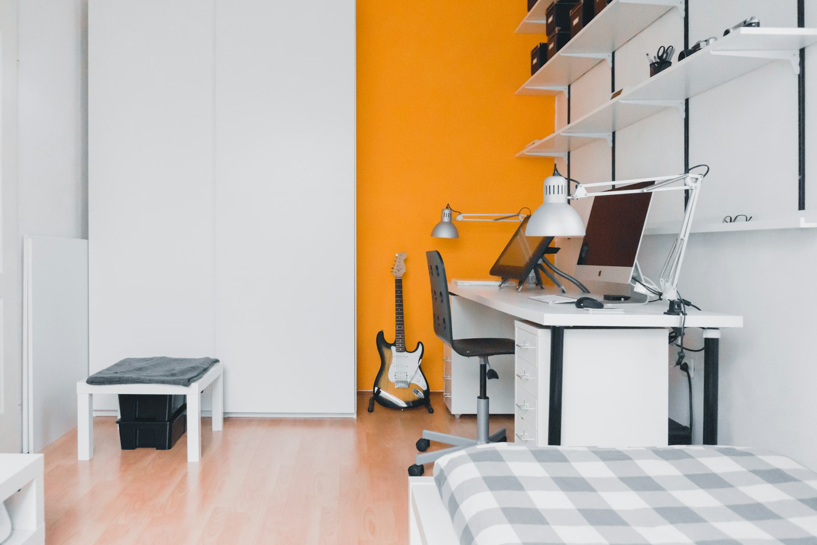 Student room with a desk against an orange wall