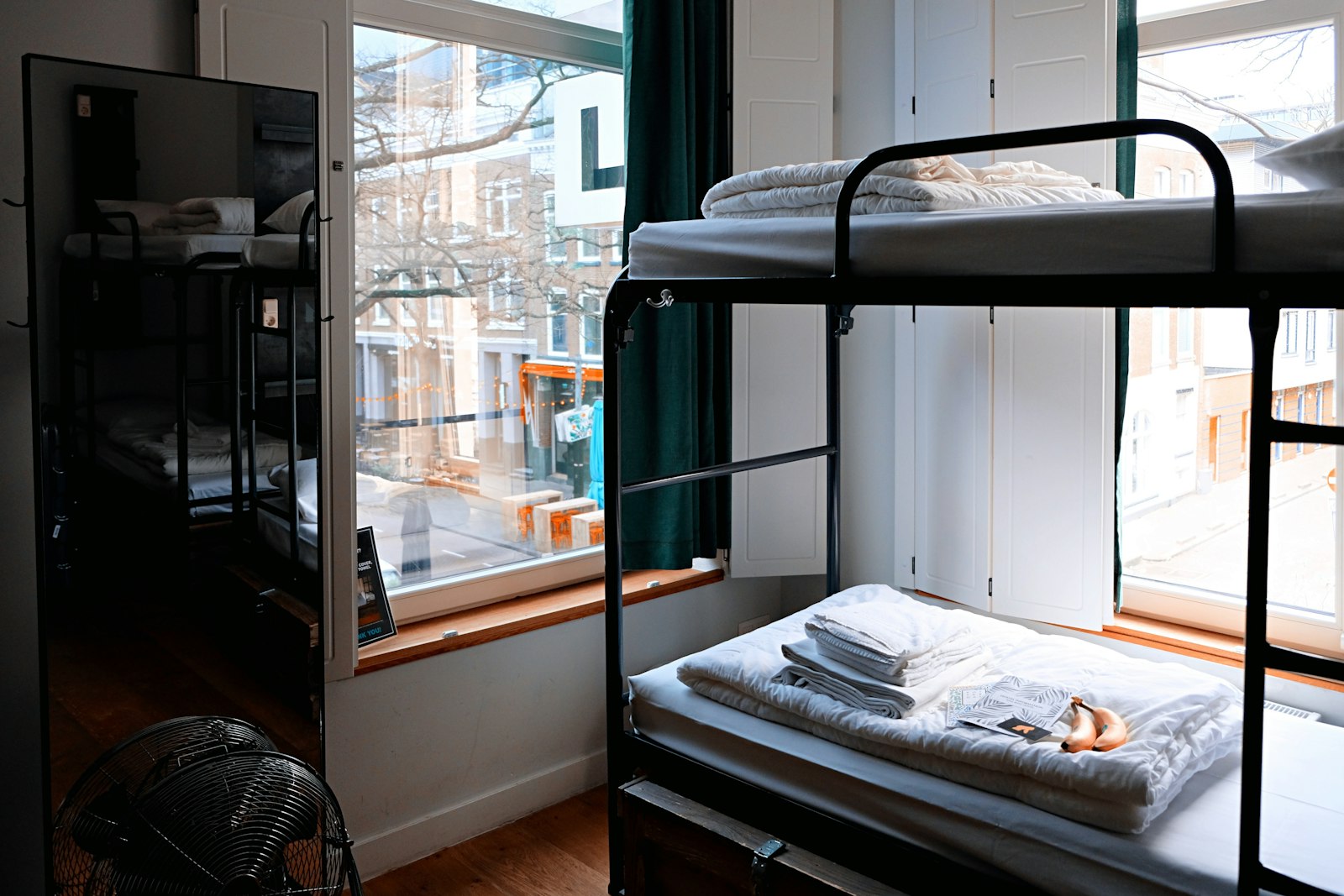 Bunk beds in a shared room by a window