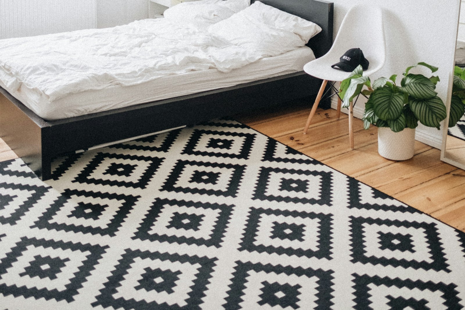 White bedroom with framed prints above the bed